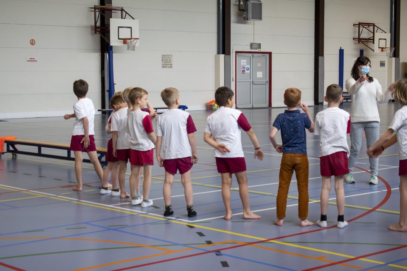 Leerlingen in turnkledij in de sporthal